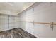 Walk-in closet with shelving and rod system, plus wood-look floors at 4910 Cielo Ct, Pahrump, NV 89061