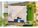 Aerial view of a house with a tile roof and solar panels overlooking a well-maintained backyard at 4914 E Beacon Ridge Dr, Pahrump, NV 89061
