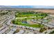 High aerial view showcasing a golf course community, complete with winding roads, lakes and desert landscape at 4914 E Beacon Ridge Dr, Pahrump, NV 89061