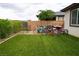 Charming backyard with artificial turf, colorful bicycles, and a brick wall at 4914 E Beacon Ridge Dr, Pahrump, NV 89061
