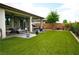 Well-maintained backyard featuring artificial grass, a patio, and outdoor furniture at 4914 E Beacon Ridge Dr, Pahrump, NV 89061