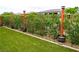 Backyard with an artificial lawn features lush landscaping and privacy fence at 4914 E Beacon Ridge Dr, Pahrump, NV 89061