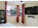 Bright bedroom with two windows featuring privacy blinds and elegant curtains at 4914 E Beacon Ridge Dr, Pahrump, NV 89061