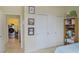 Bedroom featuring a closet with sliding doors, tile flooring, and natural light at 4914 E Beacon Ridge Dr, Pahrump, NV 89061