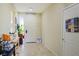 Bright hallway with tile flooring, complemented by décor and a view to the front of the home at 4914 E Beacon Ridge Dr, Pahrump, NV 89061