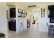 Inviting hallway with decorations, a view to the front door, and a view to the kitchen at 4914 E Beacon Ridge Dr, Pahrump, NV 89061