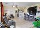 A living room with a ceiling fan, comfortable seating, and a dining area at 4914 E Beacon Ridge Dr, Pahrump, NV 89061