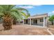 Spacious backyard featuring a covered patio and mature landscaping at 523 Rancho Del Norte Dr, North Las Vegas, NV 89031