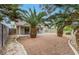 Wide backyard with a patio, palm trees, and privacy fence at 523 Rancho Del Norte Dr, North Las Vegas, NV 89031