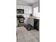 Modern kitchen features stainless steel appliances, white cabinetry, and tile flooring at 523 Rancho Del Norte Dr, North Las Vegas, NV 89031