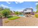 Sprawling backyard with in-ground pool, putting green, and lounge chairs at 5361 Cabrito Dr, Las Vegas, NV 89103