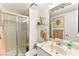 Well-lit bathroom featuring a marble countertop sink and glass-enclosed shower at 5361 Cabrito Dr, Las Vegas, NV 89103