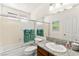 Bathroom with granite counters, integrated sink, shower over tub, and green accent towels at 5361 Cabrito Dr, Las Vegas, NV 89103