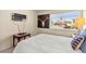 Bedroom with white linens, view to outside, and flatscreen TV at 5361 Cabrito Dr, Las Vegas, NV 89103