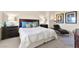 Comfortable bedroom with dark wood furniture, decorative lamps, and a lounge chair at 5361 Cabrito Dr, Las Vegas, NV 89103
