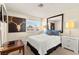 Bedroom featuring white linens and blue pillows, a flatscreen tv, and a large mirror at 5361 Cabrito Dr, Las Vegas, NV 89103