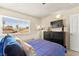 Bedroom featuring window view and flatscreen tv and dark wood accents at 5361 Cabrito Dr, Las Vegas, NV 89103