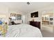 Bright bedroom with a bed, TV, dresser, and closet with mirrored doors at 5361 Cabrito Dr, Las Vegas, NV 89103