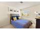 Bedroom featuring gray headboard and blue and yellow pillows, with a window view at 5361 Cabrito Dr, Las Vegas, NV 89103