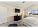 Bedroom featuring a comfortable bed, large window, and dark wood dresser with a TV at 5361 Cabrito Dr, Las Vegas, NV 89103