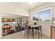 The dining area has modern gray chairs, a wood table, and an open view of the Gathering room at 5361 Cabrito Dr, Las Vegas, NV 89103