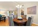 Inviting dining room with modern decor, hardwood floors, and a view to kitchen and living area at 5361 Cabrito Dr, Las Vegas, NV 89103