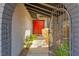 Charming entrance with a brick archway and a bright red double-door entry at 5361 Cabrito Dr, Las Vegas, NV 89103