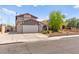Two-story home with a two-car garage, brick landscaping, and a red tile roof at 5361 Cabrito Dr, Las Vegas, NV 89103