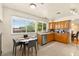 Bright eat-in kitchen with wood cabinets, granite countertops, and an adjacent dining area with large windows at 5361 Cabrito Dr, Las Vegas, NV 89103