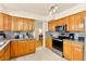 Traditional kitchen features wood cabinets, stainless steel appliances, and gray marble countertops at 5361 Cabrito Dr, Las Vegas, NV 89103