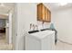 Laundry room with a washer, dryer, and upper cabinets for plenty of storage space at 5361 Cabrito Dr, Las Vegas, NV 89103