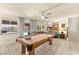 Large living area with a pool table, comfortable seating, and view to the backyard pool at 5361 Cabrito Dr, Las Vegas, NV 89103