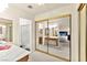 Bright main bedroom featuring mirrored closet doors, en-suite bathroom, and bedroom views at 5361 Cabrito Dr, Las Vegas, NV 89103
