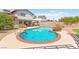 Backyard featuring a refreshing swimming pool with a red brick border and green landscaping at 5361 Cabrito Dr, Las Vegas, NV 89103