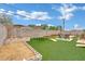Spacious backyard featuring artificial grass, a trampoline, and room for outdoor activities at 5512 Kettering Pl, Las Vegas, NV 89107