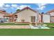Comfortable backyard showcasing artificial grass, stone pathway, and outdoor seating area at 5512 Kettering Pl, Las Vegas, NV 89107