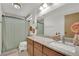 Neutral bathroom features a long granite countertop vanity and a shower/tub combo with a curtain at 5512 Kettering Pl, Las Vegas, NV 89107