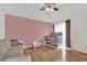Bedroom features light mauve walls, hardwood floors, and a cozy sitting area at 5512 Kettering Pl, Las Vegas, NV 89107