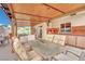 Covered patio with wooden ceiling, dining area and outdoor kitchen perfect for entertaining at 5512 Kettering Pl, Las Vegas, NV 89107