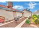 Exterior view of home showing access to the garage, landscaped area and AC unit on the roof at 5512 Kettering Pl, Las Vegas, NV 89107