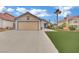 Attractive single-story home with a two-car garage, desert landscaping and a concrete driveway at 5512 Kettering Pl, Las Vegas, NV 89107