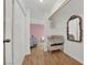 A hallway features hardwood floors and decor as well as access to multiple rooms at 5512 Kettering Pl, Las Vegas, NV 89107