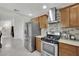 This kitchen features stainless steel appliances, wood cabinets, and granite countertops at 5512 Kettering Pl, Las Vegas, NV 89107