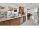 Bright kitchen with stainless steel appliances, wood cabinets, and a view to the covered outdoor patio at 5512 Kettering Pl, Las Vegas, NV 89107