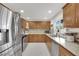 Updated kitchen featuring stainless steel appliances, tile backsplash, and granite countertops at 5512 Kettering Pl, Las Vegas, NV 89107