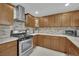 A full kitchen view features stainless steel appliances and wood cabinetry with granite countertops at 5512 Kettering Pl, Las Vegas, NV 89107