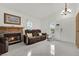 Bright living room with a fireplace, tile flooring and front door access at 5512 Kettering Pl, Las Vegas, NV 89107