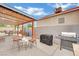 Outdoor patio with grills, seating, and a covered area, perfect for outdoor cooking and dining at 5512 Kettering Pl, Las Vegas, NV 89107