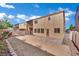 Exterior view of the rear of the home with a low maintenance backyard and patio area at 6525 Bismark Hills St, North Las Vegas, NV 89084