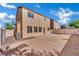 Rear home exterior with low-maintenance yard, air conditioning unit and partially covered patio at 6525 Bismark Hills St, North Las Vegas, NV 89084
